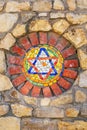 Mosaic star of David on stone wall