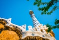 Mosaic tower and colorful roof decorations of Gingerbread House of Gaudi in Park Guell, Barcelona, Spain