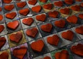 Mosaic of Valentine hearts made from red wood on multi-colored p