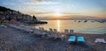 Moscenicka Draga gravel beach with empty sunloungers in the early morning, panorama croatian tourist resort
