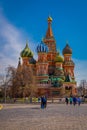 MOSCOS, RUSSIA- APRIL, 24, 2018: Outdoor view of unidentified people walking close to St. Basil`s Cathedral and Royalty Free Stock Photo