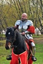 Portrait of a man in historical costume, he rides a black horse