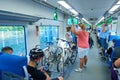 MOSCOW, AUG.29, 2018: View on seating and standing people and bikes in a special parking holder in new modern passenger train salo