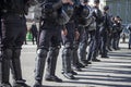 Russian police in protective gear opposes the demonstrators during opposition protests