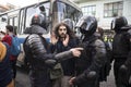 Riot police officers detain a participant of an unsanctioned walk after meeting