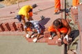 : Workers in uniform are installing a curbstone. Landscaping