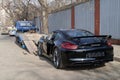 Moscow. Autumn 2018. Black Porsche Cayman GT4 on the street is loaded onto a tow truck for transportation