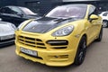 Moscow. Autumn 2018. Yellow Porsche Cayenne E2 with wide body. Tuned bumper and black carbon hood. Parked on the street