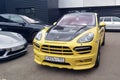 Moscow. Autumn 2018. Yellow Porsche Cayenne E2 with wide body. Tuned bumper and black carbon hood. Parked on the street