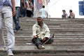 Moscow. The beggarly is sitting on the step