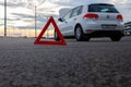 Car emergency or breakdown on highway road, waiting for roadside assistance. White automobile with open bonnet