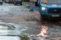 Cars after heavy rain driving in water flood, fixed route taxi-bus closeup Royalty Free Stock Photo