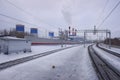 Moscow Central Cirlce railway tracks with industrial buildings in background. Cloudy winter view.