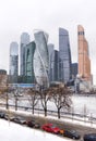 Moscow city business center from the embankment of the Moscow river in winter, Parking with cars, snow