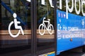 City electric bus, close-up of glass doors and side view with icons for disabled person, bicycle, elderly person