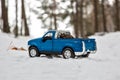 Moscow. December 2018. Blue Pickup truck Ford F350 in snow forest. Fir cones in the back of a toy car body. Winter road Royalty Free Stock Photo