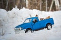 Moscow. December 2018. Blue toy Pickup truck Ford F350 in snow forest. Carrying fir cones. Winter road Royalty Free Stock Photo