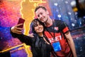 MOSCOW - DECEMBER 23 2019: esports Counter-Strike: Global Offensive event. Happy beautiful girl fan making selfie with Royalty Free Stock Photo