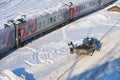 MOSCOW, FEB. 01, 2018: Winter day view on railway passenger coaches cars under snow and ice on roofs and maintenance workers. Char