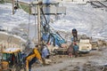 MOSCOW, FEB. 01, 2018: Winter view on dirty heavy construction equipment, vehicles workers at work. Drilling operations on constru