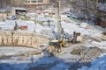 MOSCOW, FEB. 01, 2018: Winter view on dirty heavy construction equipment, vehicles workers at work. Drilling operations on constru Royalty Free Stock Photo