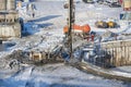 MOSCOW, FEB. 01, 2018: Winter view on dirty heavy construction equipment, vehicles and workers at work. Drilling operations on con
