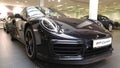 Moscow. February 2018. Black Porsche 911 991 Carrera at dealer showroom. Headlights and aerodynamic turbo packed Front and side Royalty Free Stock Photo