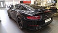 Moscow. February 2018. Black Porsche 911 991 Carrera at dealer showroom. Taillights and aerodynamic spoiler. Back and side view Royalty Free Stock Photo