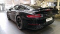 Moscow. February 2018. Black Porsche 911 991 Carrera at dealer showroom. Taillights and aerodynamic spoiler. Back and side view Royalty Free Stock Photo