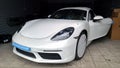 Moscow. February 2019. New white Porsche Boxster 718 in service station. Car in the shipping film. Wrapped for transportation. Pre