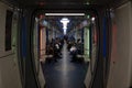 Passengers and pass through Moskva subway train in Moscow metropolitan, Russia. Interior view.