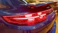 Moscow. February 2019. Rear taillights of new blue Porsche Panamera Turbo with adaptive rear aerodynamic spoiler. Rain drops