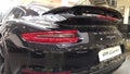 Moscow. February 2018. Taillights and aerodynamic spoiler. Back of black Porsche 911 Carrera at dealer showroom Royalty Free Stock Photo