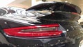 Moscow. February 2018. Taillights and aerodynamic spoiler. Back of black Porsche 911 Carrera at dealer showroom Royalty Free Stock Photo