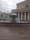 Moscow fountain against the backdrop of the Bolshoi theatre and the gray sky