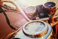 Fragment of old fashioned motorcycle with handlebar and dashboard in sun glare, tinted Royalty Free Stock Photo