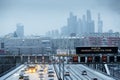 Moscow after heavy snowfall: snow-covered busy highway near Kutuzovskiy prospekt and City skyscrapers