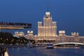 Moscow iconic skyscraper and soaring flying bridge in Zariadye park in twilight. Royalty Free Stock Photo