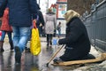 Moscow-January 31, 2016. Woman beggar with walking stick asking for money on Moscow street in winter