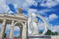 View on VDNKh entrance gate with golden sculpture and 80 years anniversary design sing in front. USSR perio