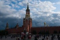 Moscow, the Kremlin, the Mausoleum on Red Square and many tourists of different nationalities walk on a cold summer cloudy cloudy