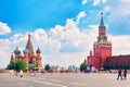 Moscow landscape. Red Square with Spasskaya Tower of the Moscow Kremlin and St. Basil`s Cathedral. Summer sunny day