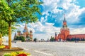 Moscow landscape. Red Square with Spasskaya Tower of the Moscow Kremlin and St. Basil`s Cathedral. Summer sunny day