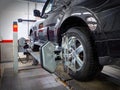 MOSCOW, MAR,02, 2017: Car automobile wheel alignment maintenance works repair at automotive service center workshop. Technical mai Royalty Free Stock Photo