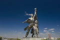 Sculpture monument Worker and female Collective farmer Rabochiy i Kolkhoznitsa with sickle and hammer on museum pavilion roof