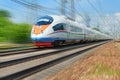 MOSCOW, MAY, 18, 2018: Diagonal view on high speed train runs on rail way tracks and trees in the background. Russian railways ele