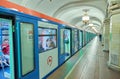 MOSCOW, MAY, 13, 2018: Perspective view of new modern subway passenger blue white train at metro station. People inside train. Rus