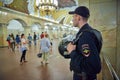 MOSCOW, MAY, 13, 2018: Russian police man in bulletproof vest at metro railway station Komsomolskaya with people in the background