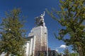 Sculpture monument Worker and female Collective farmer Rabochiy i Kolkhoznitsa with sickle and hammer on museum pavilion roof