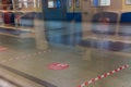 Moscow metro platform through glass, marked with stickers to maintain distance during the Covid-19 epidemic. Moscow, Russia, May